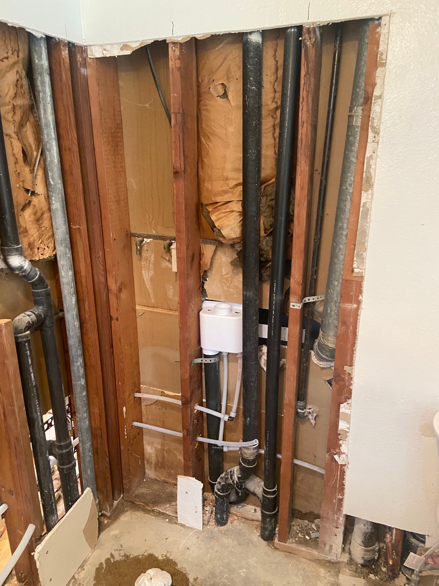 ABS and PEX piping routed through wall studs during an Orange County repipe project