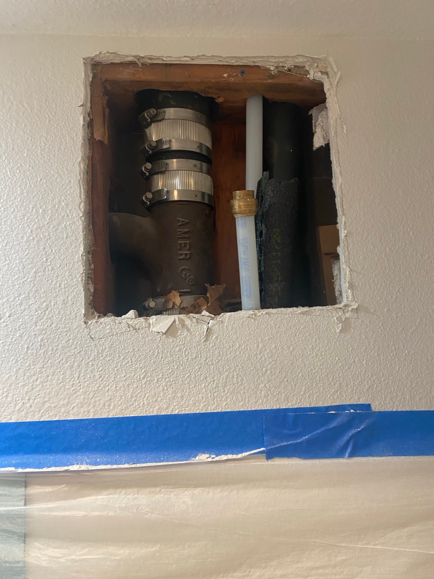 Bathroom gutted to the studs with a toilet still in place during renovation, Orange County, CA