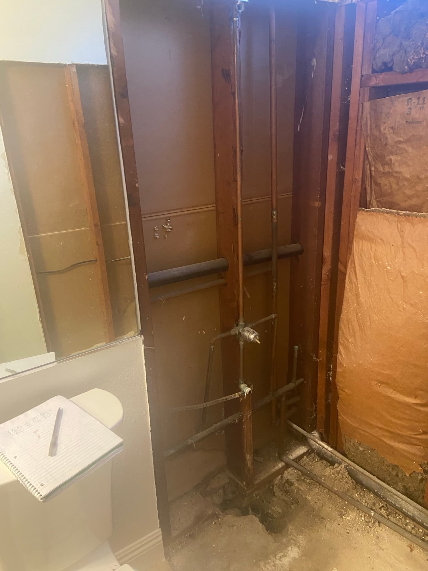 Copper water supply lines with shutoff valves running through a home crawlspace, Orange County, CA