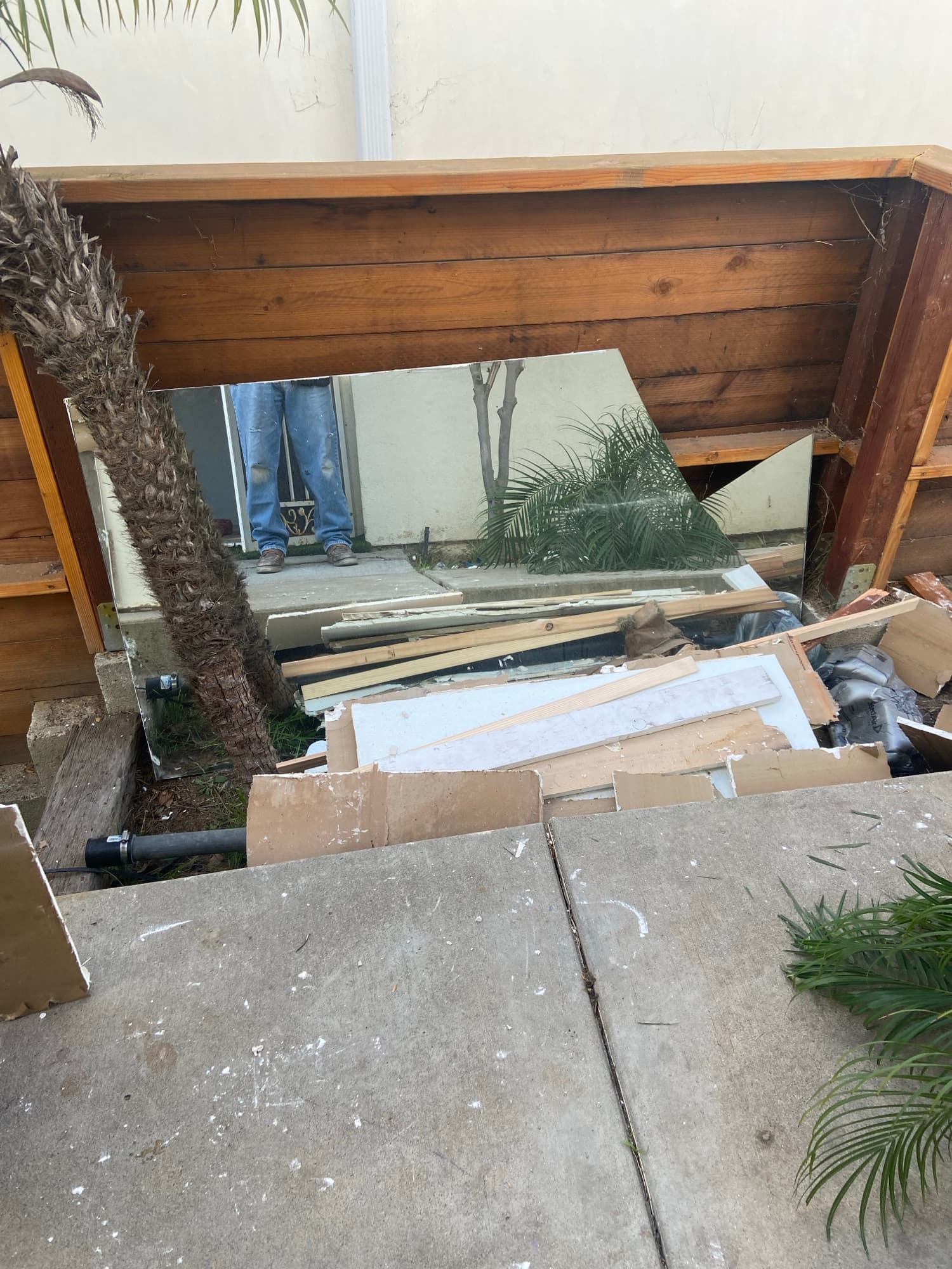 Mirror and demolition debris staged outside during a bathroom remodel teardown in Orange County, CA