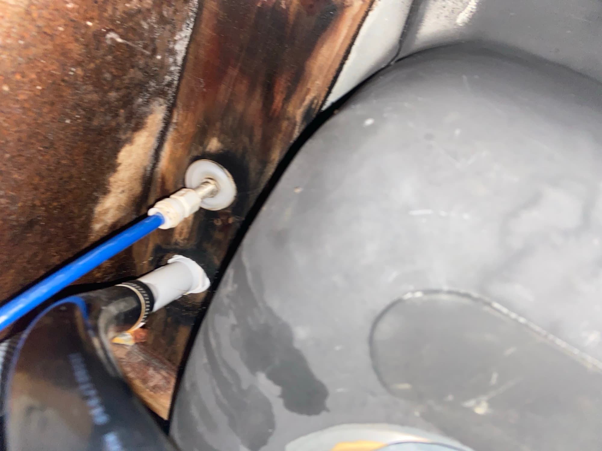 Blue PEX water supply line connected near a water heater tank, Orange County, CA