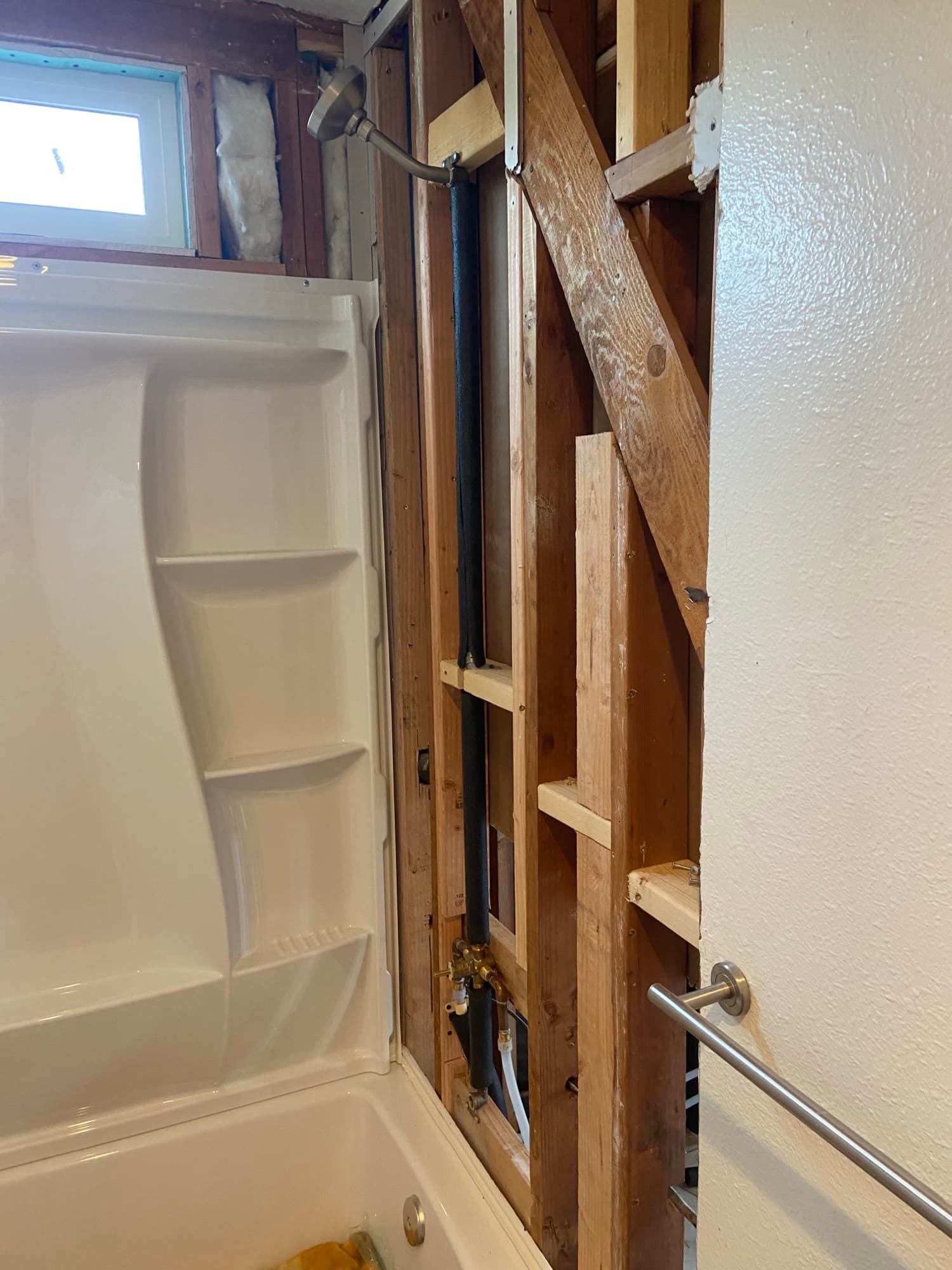 Insulated supply pipe and new shower head installed above a bathtub, Orange County, CA